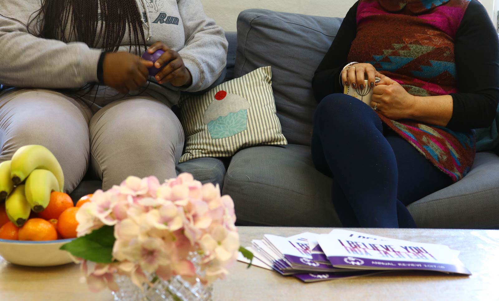 two women chatting on sofa close up view