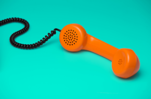 Orange helpline phone on a turquoise background